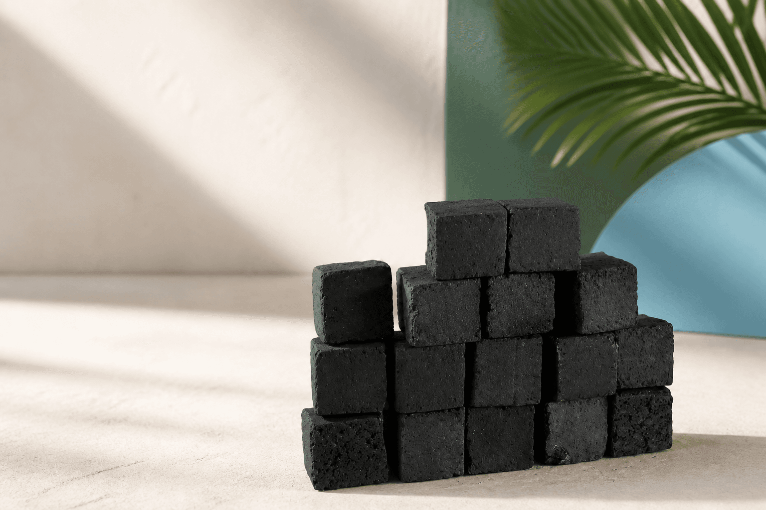 Coconut-shell charcoal briquettes arranged in a premium export presentation.